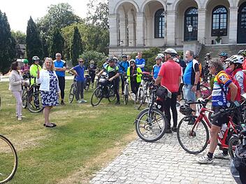 Das Staatsbad war am Nachmittag das vorletzte Etappenziel. Bad Brückenaus Kurdirektorin Andrea Schallenkammer (vorne links) pries die Vorzüge des historischen Schlossparks. Als kleine Aufmerksamkeit erhielten die Tourteilnehmer Freikarten für das Deutsche Fahrradmuseum.Rolf Pralle