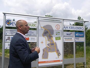 Bürgermeister Gerd Kleinhenz erklärt anhand der neuen Schautafel des Gewerbeparks am Kreuzberg die Veränderung und Chancen Wildfleckens im Zuge der Konversion. Foto: Regina Rinke