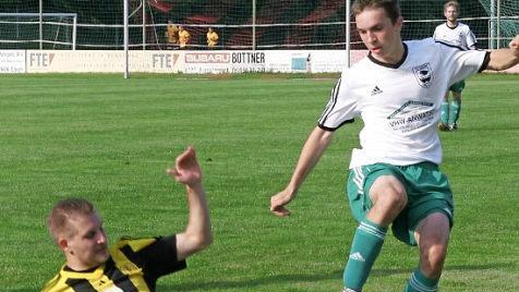 Aus dem Spiel des TV Ebern gegen den TSV Oberlauter (9:0): Der Eberner Winfried Geu&szlig; (gr&uuml;n) wird vom G&auml;steabwehrspieler in der Vorw&auml;rtsbewegung mit viel Einsatz gestoppt.  Foto: Wolfgang Dietz