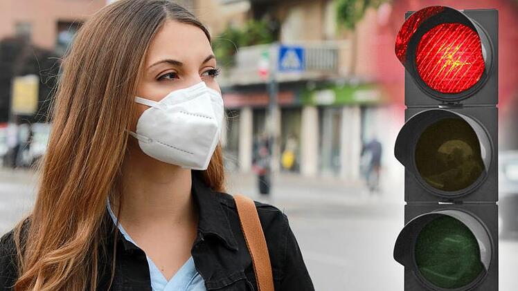 Die Corona-Ampel für den Landkreis Haßberge hat die Stufe "Rot" erreicht. Symboldbild: zigres - stock.adobe.com / Montage: Dagmar Klumb