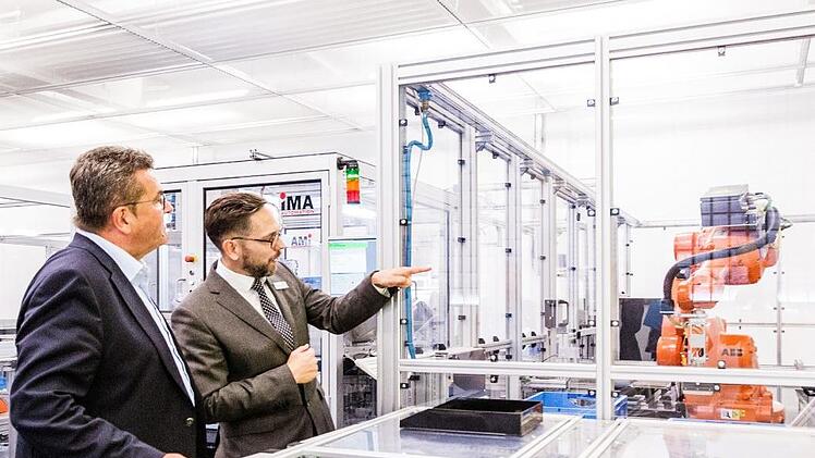 Gesch&auml;ftsf&uuml;hrer Philipp Steinberger erl&auml;utert Wirtschaftsminister Franz Josef Pschierer die Funktionsweise eines der W&ouml;hner-Fertigungsautomaten.  Foto: Kerstin Emrich