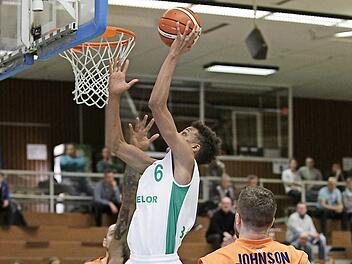 Der Baunacher Louis Olinde zieht zum Korb und schließt erfolgreich ab; vorne der Weißenfelser Dominique Johnson. Foto: sportpress
