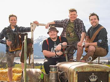 Die "Dorfrocker" Markus, Tobias und Philipp Thomann (von links) hier mit dem Comedian Thomas Willibald ("Addnfahrer"), der am Steuer sitzt, sind bald in Maßbach, um dort zwei Konzerte zu geben. Foto: Christian Pöhlmann