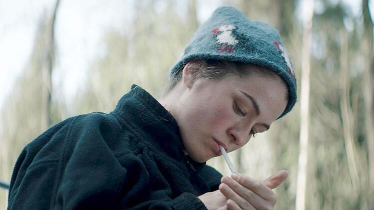 Zigarettenpause f&uuml;r Anja Grimm (Henriette Confurius): Die junge Forstpraktikantin mit dem m&auml;rchenhaften Namen untersucht den Waldboden einer engen Dorfgemeinschaft. Der Film "Schweigend steht der Wald" lief erfolgreich auf Festivals.