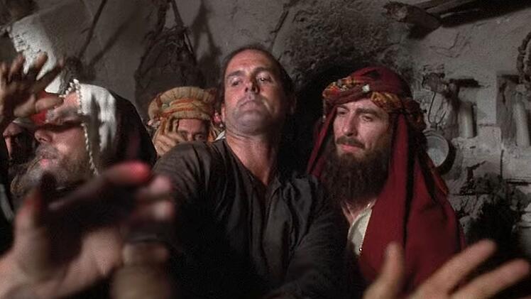 Vier Millionen Dollar lie&szlig; George Harrison f&uuml;r die Produktion von "Das Leben des Brian" springen. Daf&uuml;r durfte er in der Kom&ouml;die eine kleine Rolle spielen, einen gewissen Mr. Papadopoulos (rechts neben einer Figur von John Cleese).