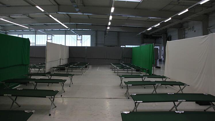 Der Schlafbereich für die alleinreisenden männlichen Flüchtlinge. Hinter der grauen Absperrung kommen die etwas kleineren Nischen für die Familien. Im vorderen Bereich der Halle ist ein Aufenthaltsraum eingerichtet. Rechts geht es zu den Sanitärcontainern.  Foto: Anja Greiner