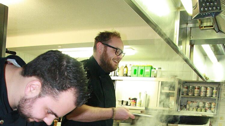Während vorne einer Reh filetiert, hantiert Michael Hergenröder mit der Pfanne. Foto: Susanne Will