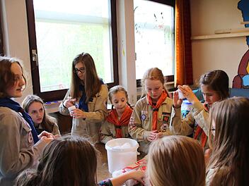 Festvorbereitungen: Für die Stationsspiele erstellen die Pfadfinderinnen Wattebällchen zum Feuerentfachen. Foto: Heike Beudert