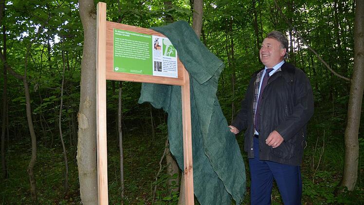 Bayerns Forstminister Helmut Brunner enthüllt eine Infotafel am Rand des erweiterten Naturwaldreservats Schwengbrunn. Fotos: Rainer Lutz