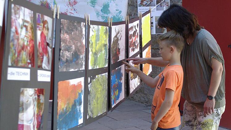 Eine Mutter und ihr Sohn "begutachten" die ausgestellten Aquarelle. Die Meinungen gehen manchmal etwas auseinander.  Foto: Winfried Ehling