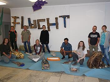 Schüler der Berufsfachschule für Holzbildhauer in Bischofsheim haben sich mit dem Thema "Flucht" beschäftigt. Ihre Werke sind jetzt in einer Ausstellung im Foyer zu bewundern. Unser Foto zeigt bei der Eröffnung (von links): Ignaz Heinroth, Gabriele Rückher-Schinko, Fachlehrer Jan Polacek, Rebekka Barth, Johanne Helle, Johnatan Araujo Sonsa, Robin Lietz, Sascha Euring und Hannah Arneke.  Foto: Marion Eckert