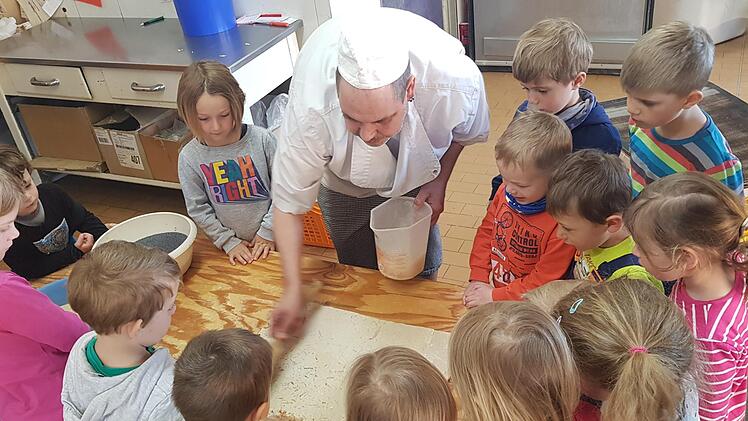 Die kleinen B&auml;cker des Kindergarten Sonnenschein haben ihre eigenen Knusperstangen in der Backstube vom Familie Schneider hergestellt. Zum Dank tr&auml;llerten sie zur bekannten Melodie der "Weihnachtsb&auml;ckerei" ein umgedichtetes Lied. Foto: Daniela Buchhold