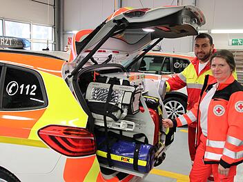 Notarzt Tarek El-Qarm steht mit einer Kollegin am Heck des Fahrzeuges und demonstriert das ärztliche Equipment. Foto: Hilmar Ruppert