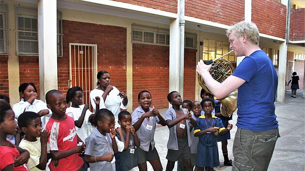 Der Hornist Christoph E&szlig; vor zehn Jahren bei einem Auftritt vor Schulkindern des s&uuml;dafrikanischen Township Kayamandi (Stellenbosch, Provinz Westkap). Foto: Archiv Gabi Zahn