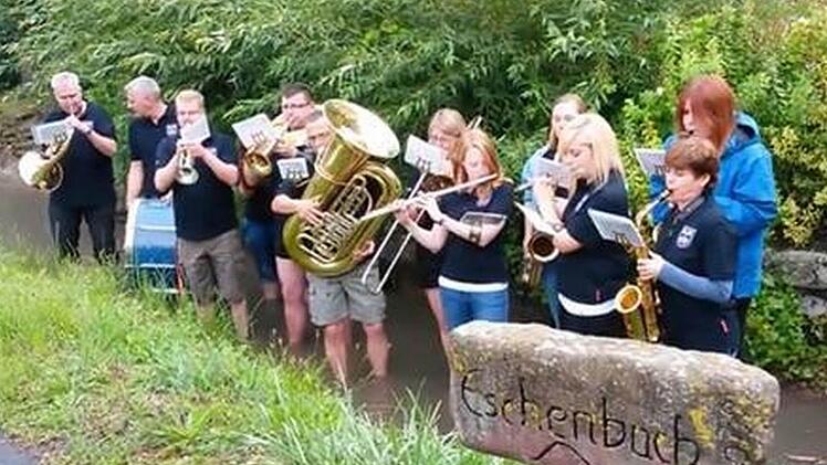 Am Eschenbach-Stein: Die Musiker spielten im Eschenbach stehend und lösten so ihre Wette ein. Foto: Verena Hebig