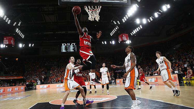 Der Bamberger Dawan Robinson zieht zwischen den Ulmern Boris Savovic (l.) und Will Clyburn (r.) hindurch zum Korb und erzielt zwei Punkte.  Foto: Daniel Löb