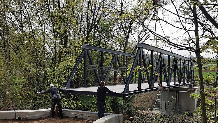 Pettstadt: Großer Kran bringt neue Brücke in Position - zweiter Bürgermeister testet Standsicherheit