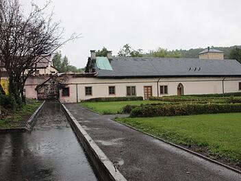 Der Brandschaden am Bäulein in Maria Bildhausen ist auf dem ersten Blick deutlich zu erkennen. Dort, wo die abgebrannte Kegelbahn stand, sammelt sich jetzt das Regenwasser. Hier wird ein Laubengang entstehen. Foto: Heike Beudert