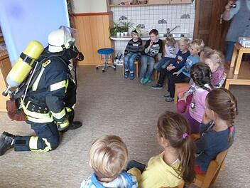 Die Atemschutzmaske beeindruckte die Kinder. Schließlich trauten sie sich aber sogar, den Feuerwehrmann anzufassen und mit ihm zu sprechen. Foto: Feuerwehr Thulba