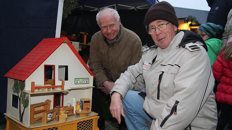 Erwin Felber und Fritz Melinger vor einer Holzpuppenstube - die Schreinerwerkstatt hat viel Sellbstgemachtes im Angebot. Foto: Sonja Adam