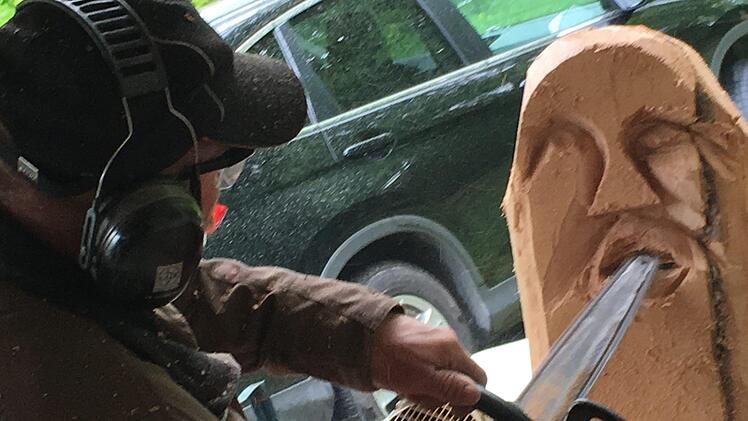 Robert Reuscher von der Kunstscheune aus Burghausen zauberte mit seiner Motorsäge in nur wenigen Minuten Gesichter in Holz. So lässt sich jede Nisthilfe verschönern.  Kerstin Väth