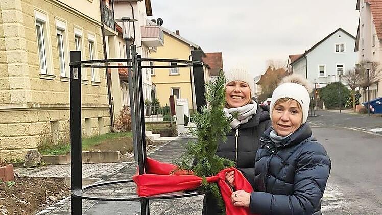 Claudia Swoboda und Dagmar Mayer verleihen den schmucklosen Baumst&auml;ndern in der Bahnhofsstra&szlig;e ein wenig weihnachtliches Flair.