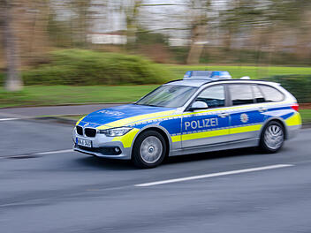 German police car drives on a street.