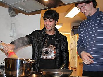 Wer essen will, muss auch kochen: Khalid aus Afghanistan steht zusammen mit Betreuer Eduard Österle am Herd. Foto: Ulrike Müller