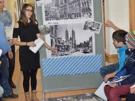 Aleyna Karatas an der Schautafel und Carina Jungkunz (2. v. l.) erklärten die Anfänge, wie es zur bayerischen Verfassung kam, und zeigten Bilder von zerbombten Städten. Foto: Karl-Heinz Hofmann