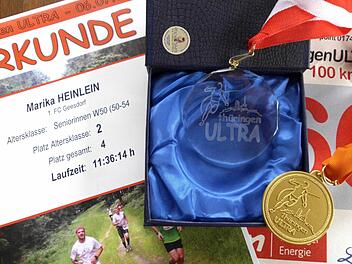 Zeugnisse eines erfolgreichen Abschneidens in Thüringen: Marika Heinleins Urkunde und Medaille des 7. Thüringen Ultra 100 Kilometerlaufes. Foto: Heinlein