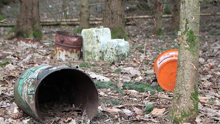 Leere Fässer, ein Eimer und Kanister liegen achtlos im Wald nahe der B 286 herum. Foto: Ulrike Müller