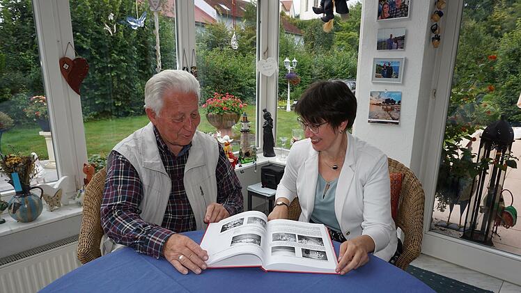 Walter Vey stellt Bürgermeisterin Sonja Rahm sein neues Buch vor. Es enthält Geschichten aus Walter Veys Leben. Foto: Marion Eckert