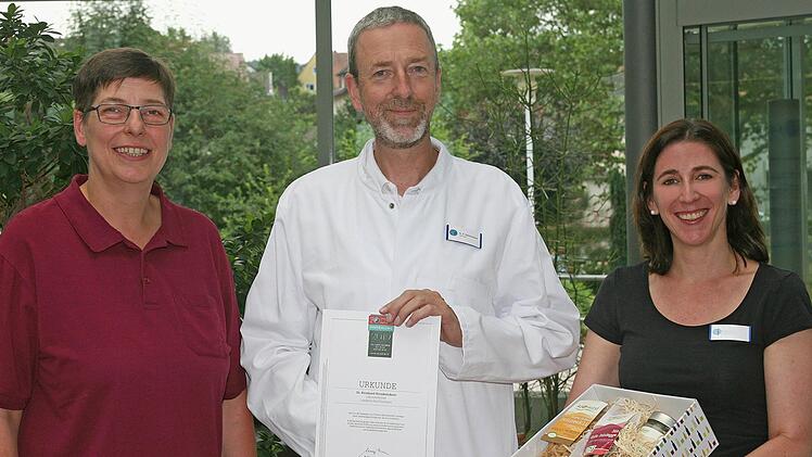 Sandra Hornung (links), Leitende MTA der Laborgemeinschaft Bad Brückenau   und die Verwaltungsdirektorin der  Capio Franz-von-Prümmer-Klinik , Sabine Hein (rechts), überreichten Dr. med. Bernhard Steinbrückner die Auszeichnung.Beate Wöhrle