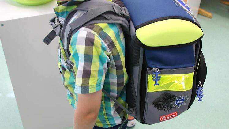 Zusammen mit seinem Ranzen zeigt die Waage bei Lorenz 26,9 Kilo an. Da der Siebenjährige 23,7 kg wiegt, trägt auch er zuviel auf dem Rücken.