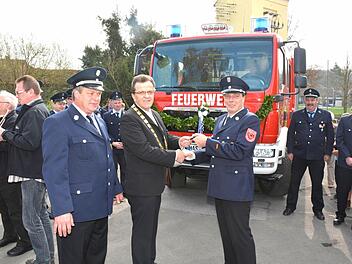Bürgermeister Werner Döhler (Mitte) übergibt den Fahrzeugschlüssel offiziell an den Kommandanten Markus Eiring (rechts) und seinem Stellvertreter Klaus Fischer (links).  Foto: Schmidt