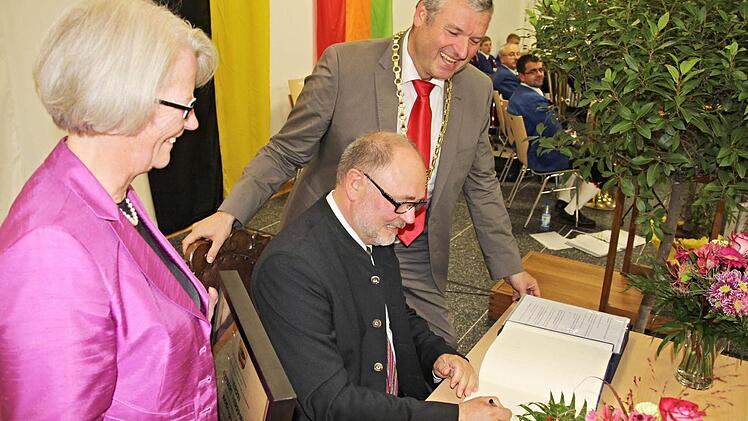 Bisher stand Altbürgermeister Robert Herrmann immer dahinter. Hier beobachten 1. Bürgermeister Jürgen Hennemann (rechts) und die Gattin des Altbürgermeisters, Christiane Herrmann (links), wie der Geehrte sich in das Goldene Buch der Stadt Ebern einträgt. Foto: Helmut Will