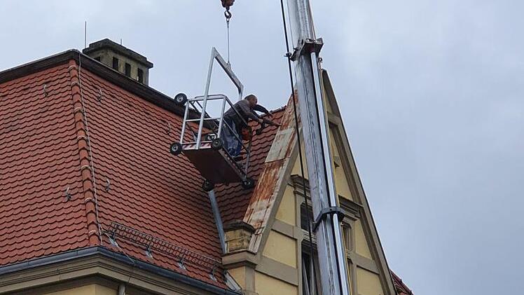 Dachdecker haben am Montag in luftiger Höhe einen Giebel des Kolpinghauses repariert, der durch Sturmtief "Kirsten" in Mitleidenschaft gezogen wurde.  Foto: Ronald Heck