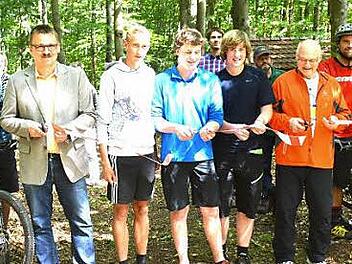 Wie bei einer Straßenfreigabe wurde die Mountainbikestrecke bei Goßmannsdorf frei gegeben. Von links an der Schere Bürgermeister Bernd Fischer (Riedbach), Philipp Behnke, Jakob Guschker, Paul Guschker, Hofheims Bürgermeister Wolfgang Borst und rechts Jagdpächter Klaus Scheuring.  Foto: Gerhard Schmidt