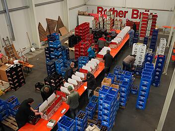 Die Mitarbeiter der verschiedenen Brauereien arbeiten beim Befüllen der Bier-Adventskalender Hand in Hand. Foto: Johannes Metz