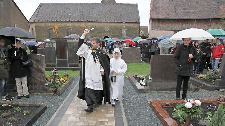 Der Pfarrer Matthias Steffel weiht den neu gestalteten Friedhof in Schnaid. Foto: Mathias Erlwein