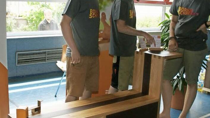 Mit seiner Garderobenbank gewann Moritz Werb den Wettbewerb "Die schöne Form". Seinen bisherigen Mit-Azubis Ulrich Spengler und Johannes Stretz (von rechts) erläuterte er die Details.  Foto: Sabine Weinbeer