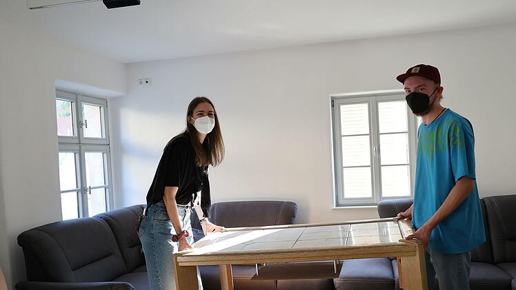 Die letzten R&auml;umarbeiten: Jule Lorenz und Anton Sch&uuml;lein stellen den Tisch an seinen sp&auml;teren Platz.