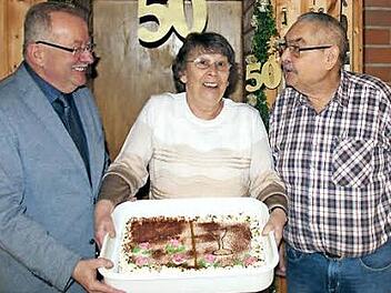 Bürgermeister Friedrich Gleitsmann sowie Anna und Roland Nachtigal mit der Jubeltorte Foto: Johanna Blum