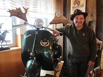 Josef Sanfilippo präsentiert in Jägerkluft die grüne Vespa "cacciatore". In den Damhirschschaufeln befinden sich übrigens die Rückspiegel - und falls ein angeschossener Keiler schnaubend die Verfolgung aufnehmen sollte, kann der türmende Waidmann seine nach hinten montierte Flinte nach der Manier von James Bond im Davonpreschen abfeuern. Fotos: Matthias Einwag