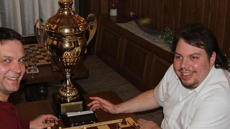Für ihn steht der Pokal eher im Hintergrund denn im Mittelpunkt: Alexander Kliche (rechts) holte nicht nur für ihn überraschend die unterfränkische Einzel-Schachmeisterschaft. Links Vereinskollege Matthias Basel, der auf Rang acht kam. Foto: Gerd Ludwig