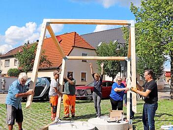 Viele Hände machen schnell ein Ende: beim Aufbau des Klimawürfels in Adelsdorf packten Mitgliedern des Bunds Naturschutz, der Pressesprecher des Vereins "Energiewende ER(H)langen", Rudi Ackermann, Bauhofmitarbeiter und Bürgermeister Karsten Fischkal mit an. Foto: Johanna Blum