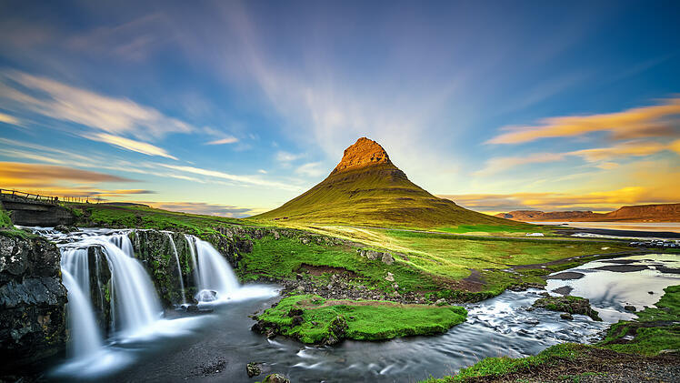 Sunset over Kirkjufellsfoss Waterfall and Kirkjufell mountain in