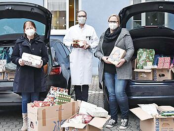 Zwei Autos voll mit Weihnachtspäckchen überbrachten Fabian Fritz (rechts) und Daniel Gambel (links) vom Nachwuchskreis der Siemens AG für die Patienten der Erlanger Kinderklinik. Klinikdirektor Prof. Joachim Wölfle nahm die Geschenke gemeinsam mit Marion Müller (Zweite von links) und Pamela Krebs entgegen.