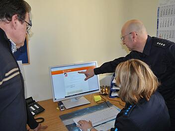 Die Polizeibeamten Gerald Storath und Anke Hagel-Burgstaller sowie der geschäftsleitende Beamte der Stadt Bad Staffelstein, Wolfgang Hörath (von rechts), beim Recherchieren auf der Marcophono-Seite im Internet.Matthias Einwag