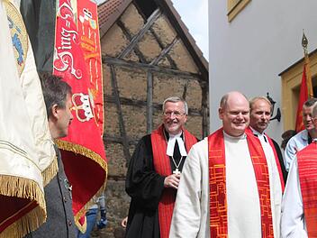 Die Fahnen der Rüdenhäuser Vereine säumten den Auszug von Regionalbischof Christian Schmidt (hinten) mit Pfarrer Martin Fromm, Pfarrer Ernst-Ludwig Werner (vorne von links) und Dekan Günter Klöss-Schuster.  Fotos: Zapf